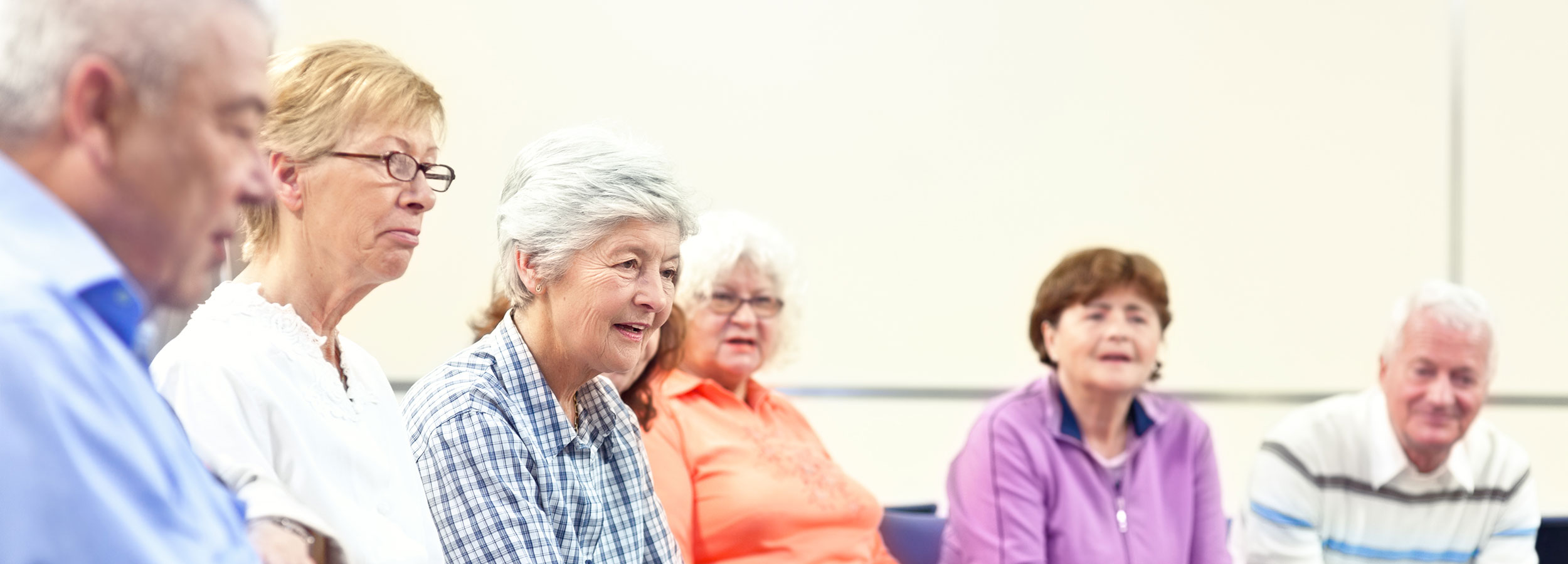 Group of caregivers attending a support group session